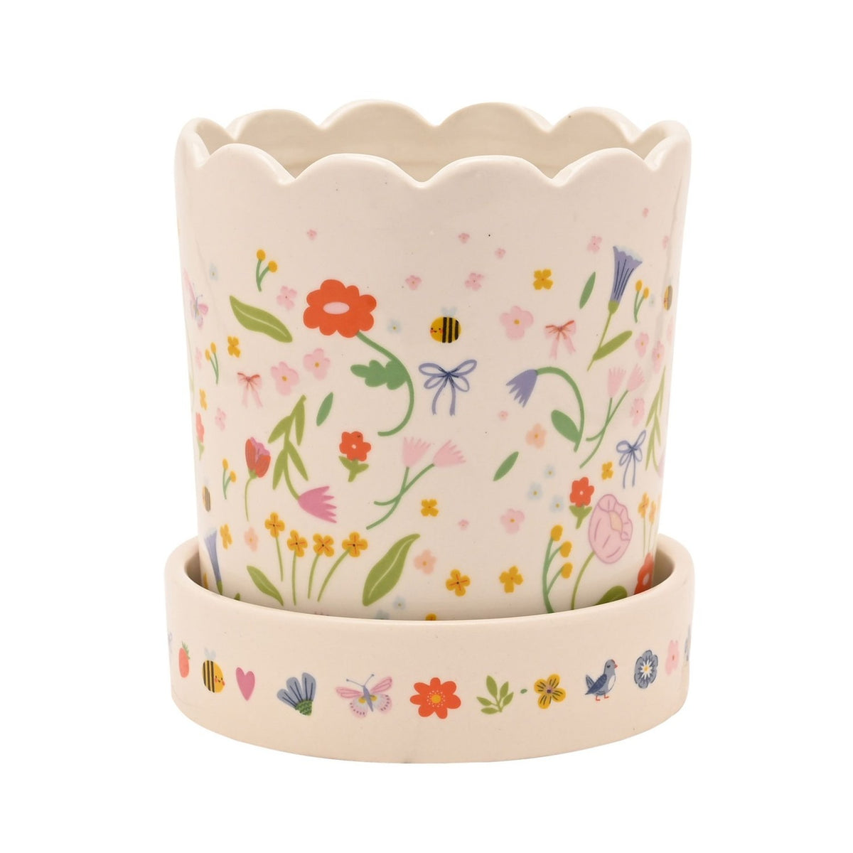 White stoneware planter with scalloped rim and matching saucer, decorated with a floral meadow print of flowers, leaves, bows and bees, shown on a plain white background.