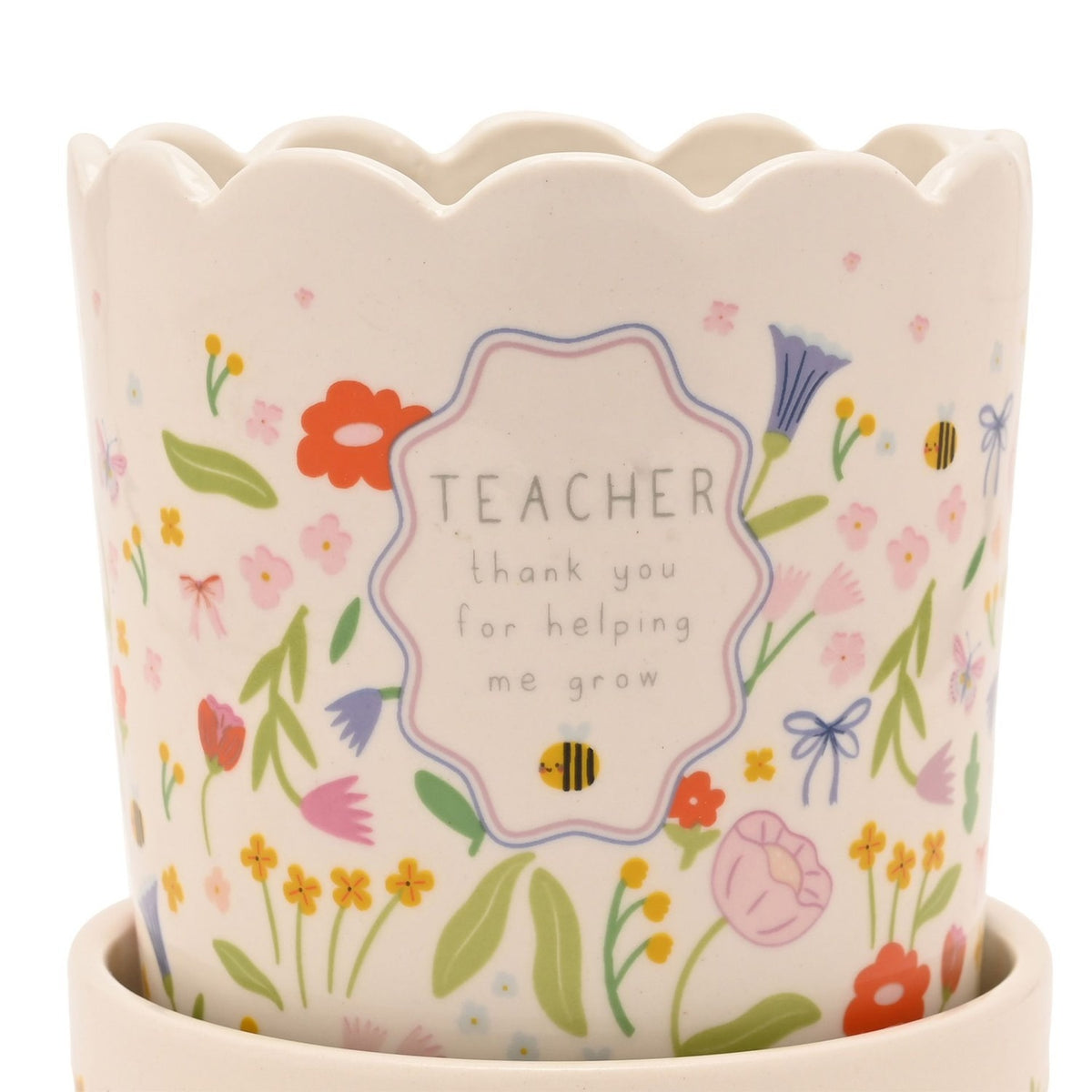 White stoneware planter with scalloped rim and saucer, featuring a floral meadow print with bees and a frame reading "TEACHER thank you for helping me grow".