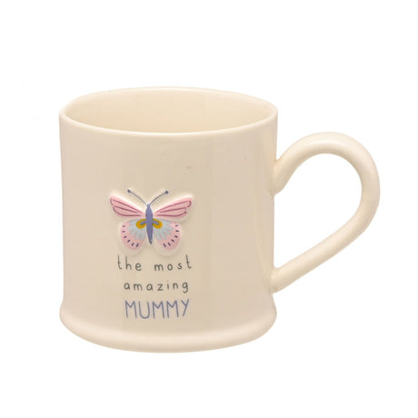 Off white stoneware mug with a C-shaped handle, featuring an embossed butterfly in pink, lilac and blue above "the most amazing MUMMY" text, shown on a plain white background.