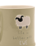 Close-up of a green stoneware mug with an embossed cream sheep design and the grey lettered text "life is better with EWE" beneath it.