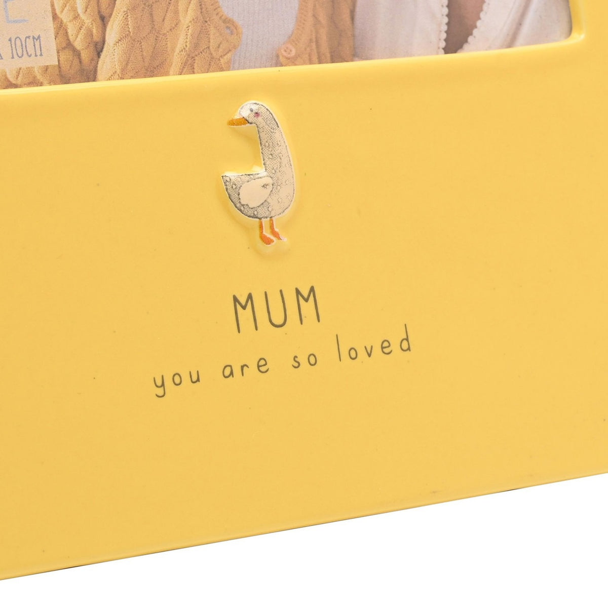 Yellow glazed stoneware photo frame for a 6 x 4in picture, with a raised goose motif above "MUM you are so loved" text, shown in close-up detail.