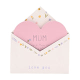 Wooden envelope plaque for Mum in white with a floral border, featuring a pink heart insert reading "MUM" and "love you" lettering on the envelope front, shown on a plain background.