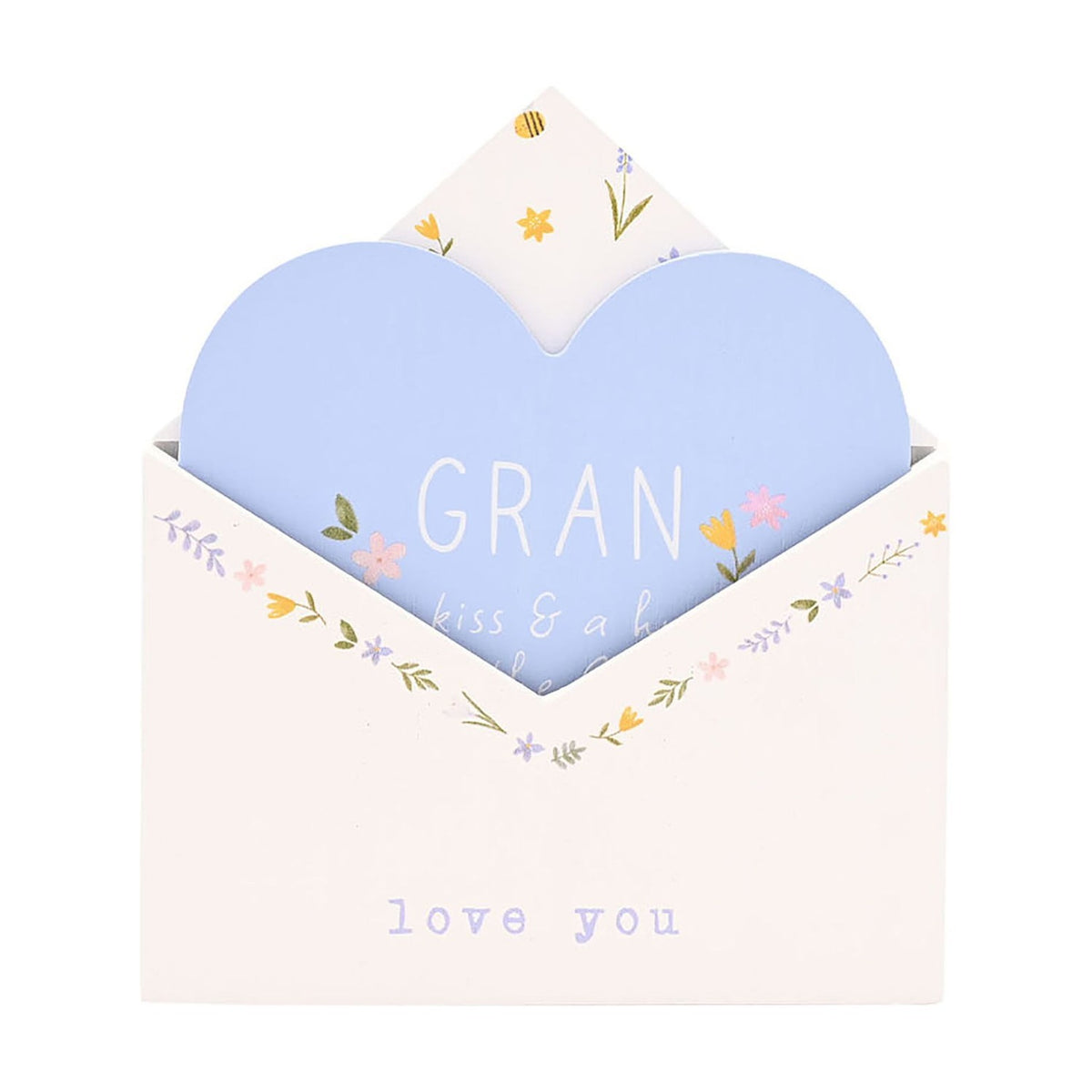White wooden envelope-shaped wall plaque with a pale blue heart insert reading "GRAN," floral details in pink, yellow and lilac, on a plain white background.