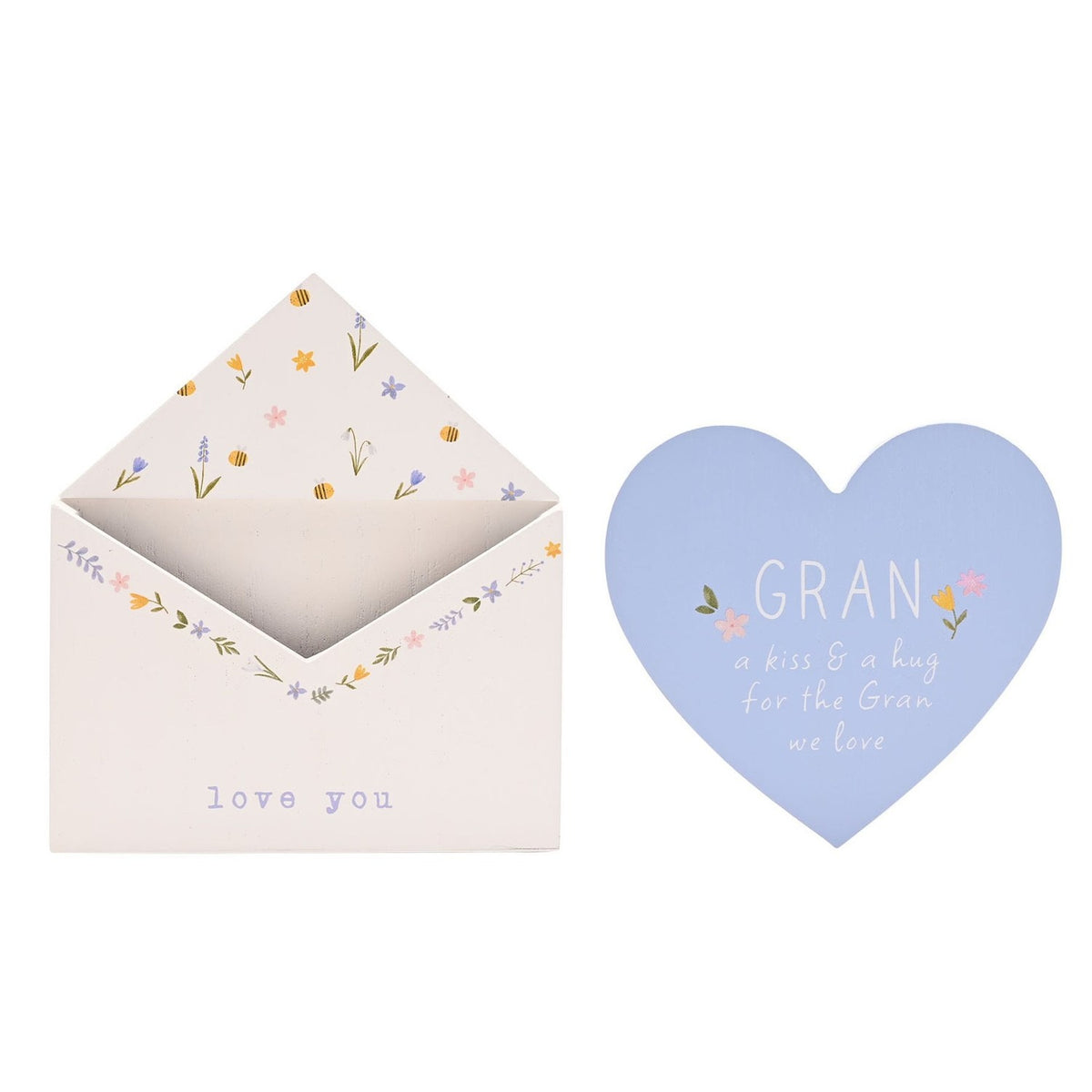 White wooden envelope plaque with floral and bee details, paired with a pale blue heart insert reading "GRAN, a kiss & a hug for the Gran we love," on a plain background.