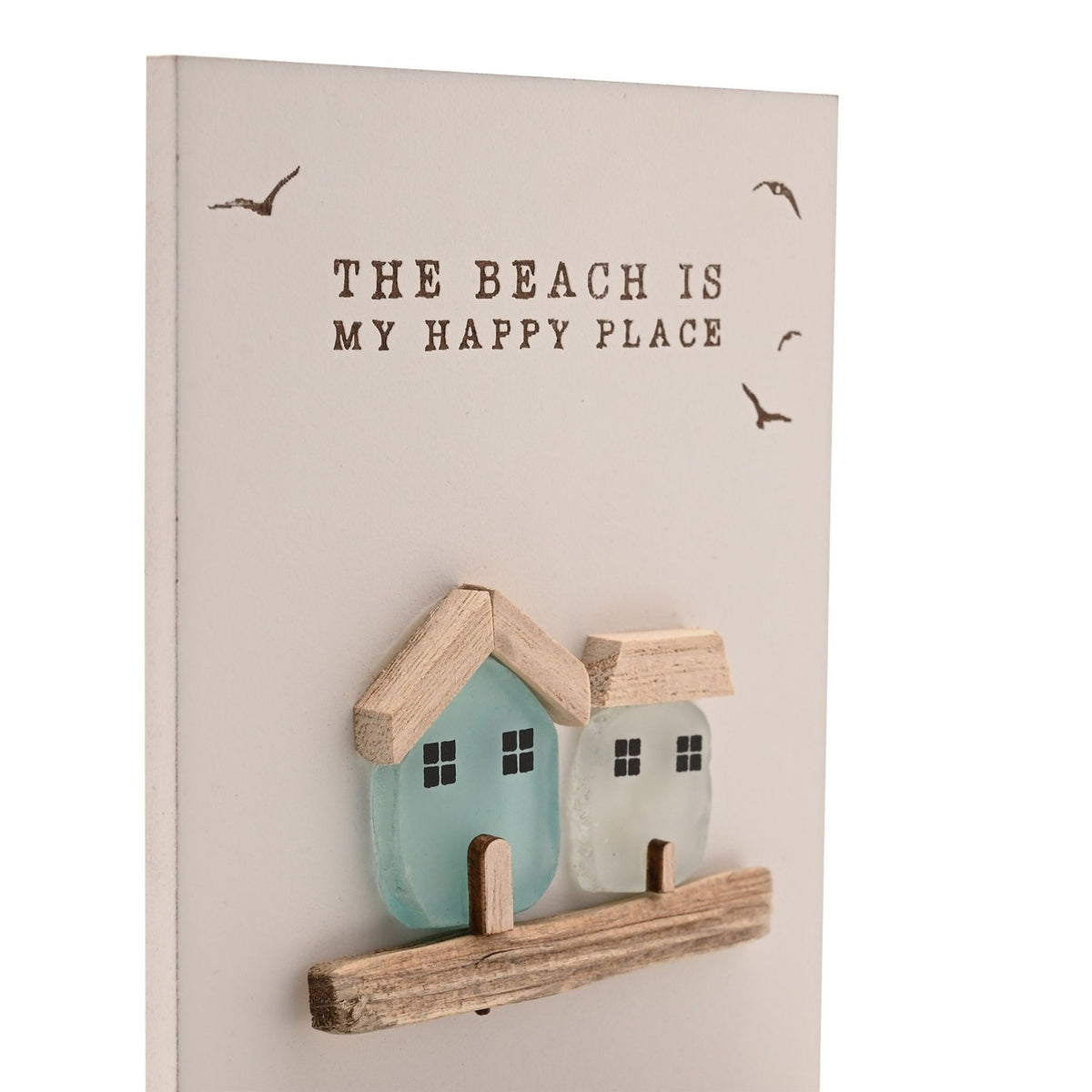 Cream rectangular tea light candle holder with "The Beach Is My Happy Place" text, bird motifs, and two sea glass houses in aqua and frosted white on a wooden ledge.