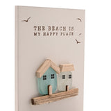 Cream rectangular tea light candle holder with "The Beach Is My Happy Place" text, bird motifs, and two sea glass houses in aqua and frosted white on a wooden ledge.