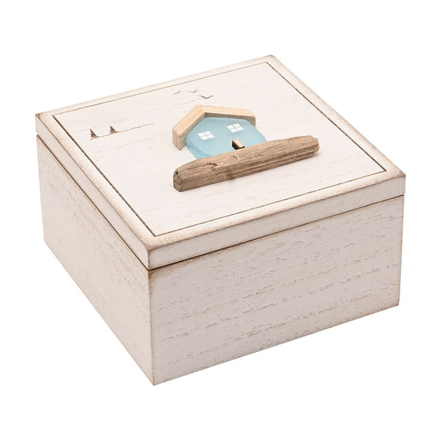 Square white wooden trinket box with hinged lid, featuring a pale blue sea glass house, driftwood accent, and etched birds and horizon on top, shown on a plain white background.