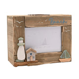Beach Driftwood Photo Trinket Box in natural wood with a 4"x6" picture window, pebble lighthouse, wooden house with blue heart, and sea glass sailboat, on a white background.