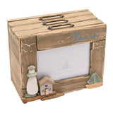 Beach Driftwood Photo Trinket Box in natural wood, with "Beach" text, a pebble lighthouse, wooden house, sea glass sailing boat, and a 4"x6" picture window, shown on a white background.