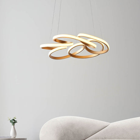 Tolmere Multi Spiral LED Pendant in satin gold by Lighting No.1, illuminated above a cream sofa in a neutral living room.