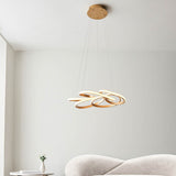 Tolmere Multi Spiral LED Pendant in satin gold by Lighting No.1, suspended from a round ceiling plate above a cream sofa in a living room.