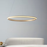 Ashenhurst LED Ring Pendant in satin gold by Lighting No.1, a slim illuminated circle suspended by cables above a cream sofa and marble side table.