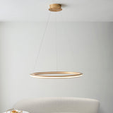 Lighting No.1 Ashenhurst LED ring pendant in satin gold, suspended from a ceiling plate by thin cables, hanging above a pale upholstered chair.