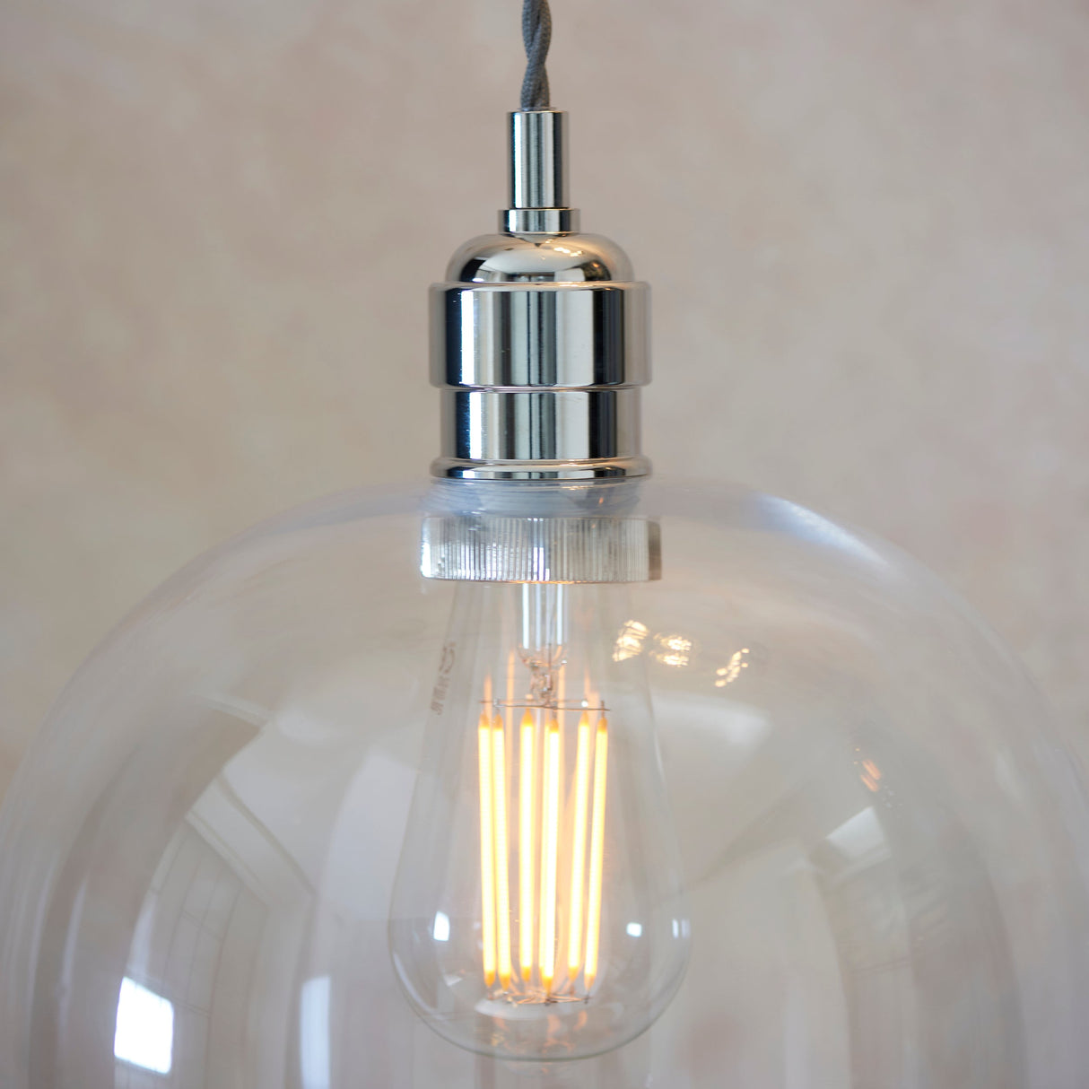 Lighting No.1 Vellmere Large Pendant in clear glass with a bright nickel fitting, close-up showing a lit filament LED E27 bulb inside.