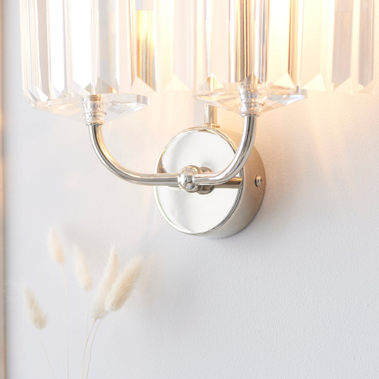 Close-up of the Calverdale Cut 2 Light Wall Light from Lighting No.1, showing the bright nickel backplate, curved arms and faceted cut glass shades.