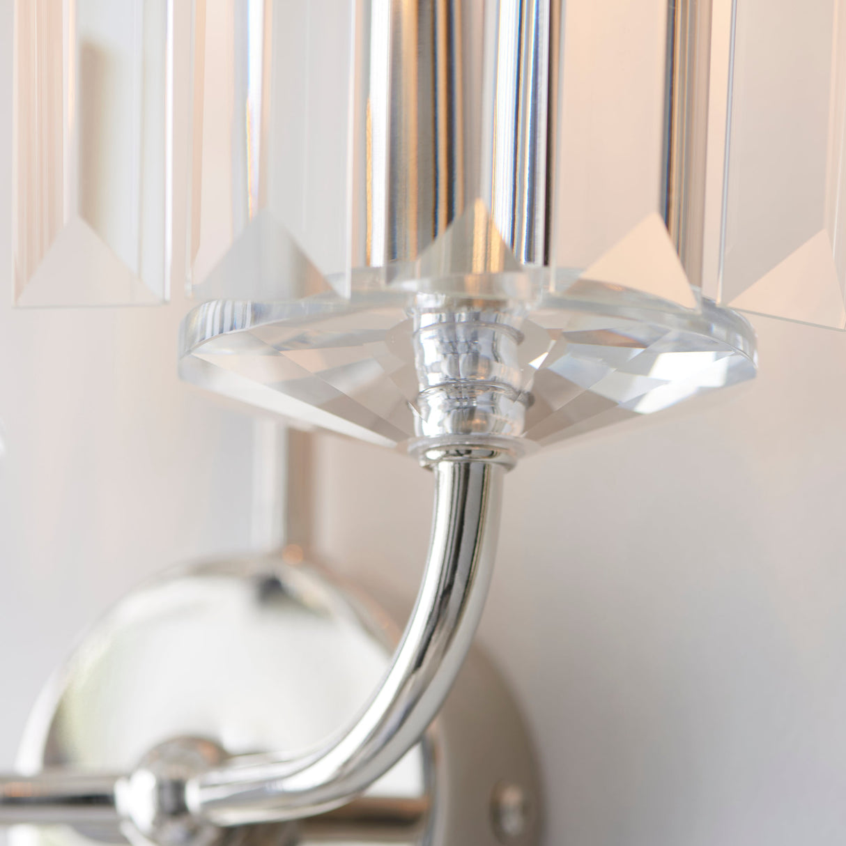 Close-up of the Calverdale Cut 2 Light Wall Light from Lighting No.1, showing the bright nickel curved arm and faceted cut glass shade.