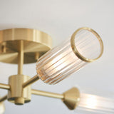 Close-up of Lighting No.1 Gorsewell Ribbed Semi-flush 4 Light ceiling light, showing satin brass arms and a ribbed frosted glass cylinder shade.
