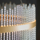 Close-up of the Lighting No.1 Rookhurst Rod Grand Pendant showing twisted clear glass rods set upright in a brushed gold circular frame.