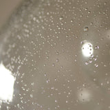 Close-up of the Lighting No.1 Yarnwell Bubble Pendant showing the clear glass dome's bubbled texture catching soft light reflections.