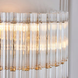 Close-up of Lighting No.1 Nettlecote 2 Light Wall Light showing clear ridged glass shades illuminated within a brushed aged brass frame.