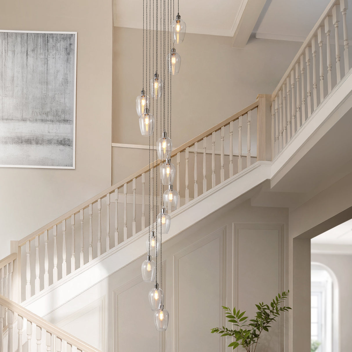 Quilbrook Cascade 13 light pendant by Lighting No.1, with clear glass globes on bright nickel suspensions cascading down a tall stairwell void.