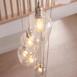 Close-up of the Lighting No.1 Quilbrook Cascade 13 light pendant showing clear glass globes with filament LED bulbs suspended on bright nickel fittings.