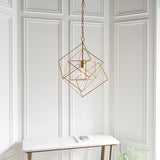 Padgrove Medium Angular Framed Single Pendant in gold leaf by Lighting No.1, hung above a marble console table against white panelled walls.