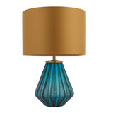 Foxleigh table lamp by Lighting No.1 with a faceted turquoise glass base and gold drum shade on a plain white background.