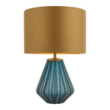 Foxleigh table lamp by Lighting No.1 with a faceted turquoise glass base and gold drum shade on a plain white background.