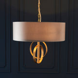 Sparrowmere Double Hoop large 3-light pendant by Lighting No.1 with a mink fabric drum shade and gold leaf hoops, suspended on a chain against dark panelling.