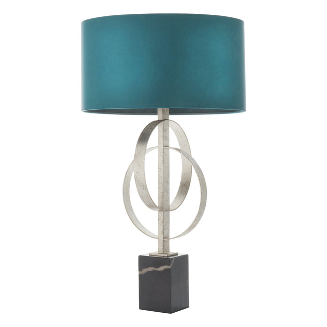 Sparrowmere Double Hoop Table Lamp in silver leaf with interlocking metal hoops, black marble base and deep teal drum shade on a white background.