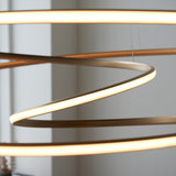 Close-up of the Tolmere Spiral Grand Pendant in natural finish by Lighting No.1, showing the coiled metal ribbon with warm integrated LED glow.