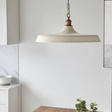 Denhollow Warm Mid Century Pendant in matt white satin with satin gold fittings and chain, hanging in a kitchen with marble splashback and eucalyptus.