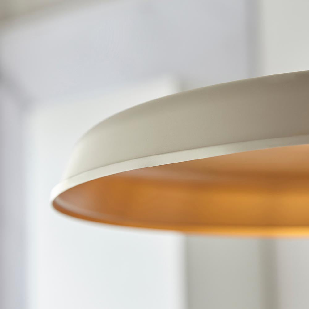 Close-up of the Denhollow Warm Mid Century Pendant from Lighting No.1, showing the matt white dome shade with satin gold interior.