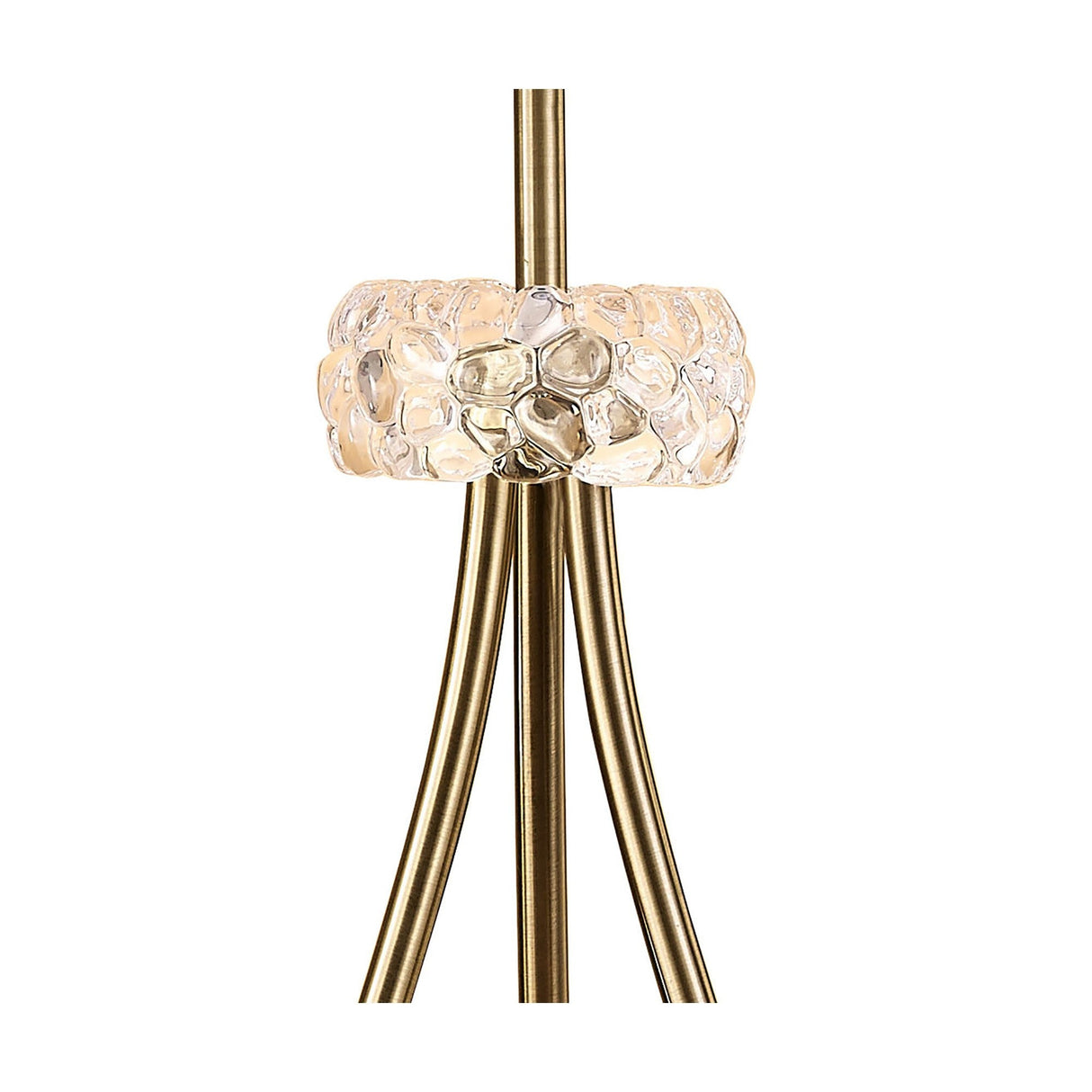 A close-up of the Loewe 3 Light Floor Lamp - Brass With Soft Bronze Shade highlights its elegant brass finish and textured glass ring, beautifully illuminated to add warmth and sophistication to any space. This dimmable lamp is perfect for modern decor.