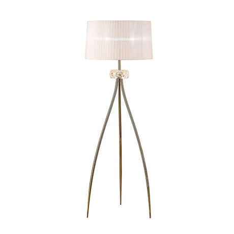 The Loewe 3 Light Floor Lamp features a modern brass finish, a white pleated drum shade, and three slender tripod legs with a glass accent below the shade—ideal for adding elegant interior lighting to any space.