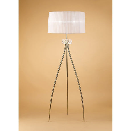 The Loewe 3 Light Floor Lamp - Brass With White Shade features a white pleated shade, clear glass accent, and gold legs for elegant lighting, shown against a beige background.