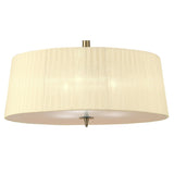 Mantra Loewe 3 light pendant with cream pleated organza drum shade and antique brass stem, viewed from below showing diffuser and finial.