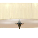 Close-up of Mantra Loewe pendant light showing cream pleated organza shade edge with antique brass cone finial detail on a white background.