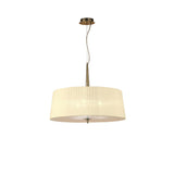 Mantra Loewe 3 light pendant with antique brass stem and canopy and a wide cream pleated fabric drum shade, shown on a plain white background.