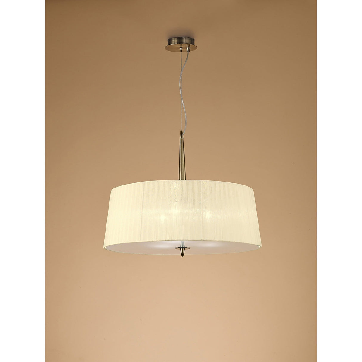 Mantra Loewe 3 light pendant in antique brass with a wide cream pleated organza drum shade, suspended from a slim stem against a neutral background.