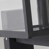 A close-up of the Lofoten Outdoor 1 Light Wall Light in black displays a modern, minimalist design with a sleek metal frame and transparent glass panel. The IP44 rated design boasts clean lines and a geometric style, highlighting its contemporary aesthetic suited for any exterior decor.
