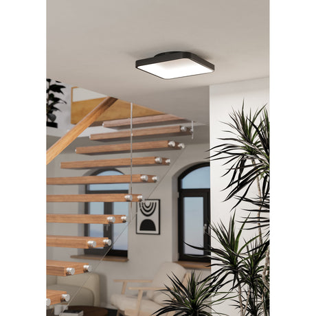 Loretello Smart LED Flush Ceiling Light in black, 35 x 35cm square design with white plastic shade, mounted on a white ceiling above a wooden staircase.