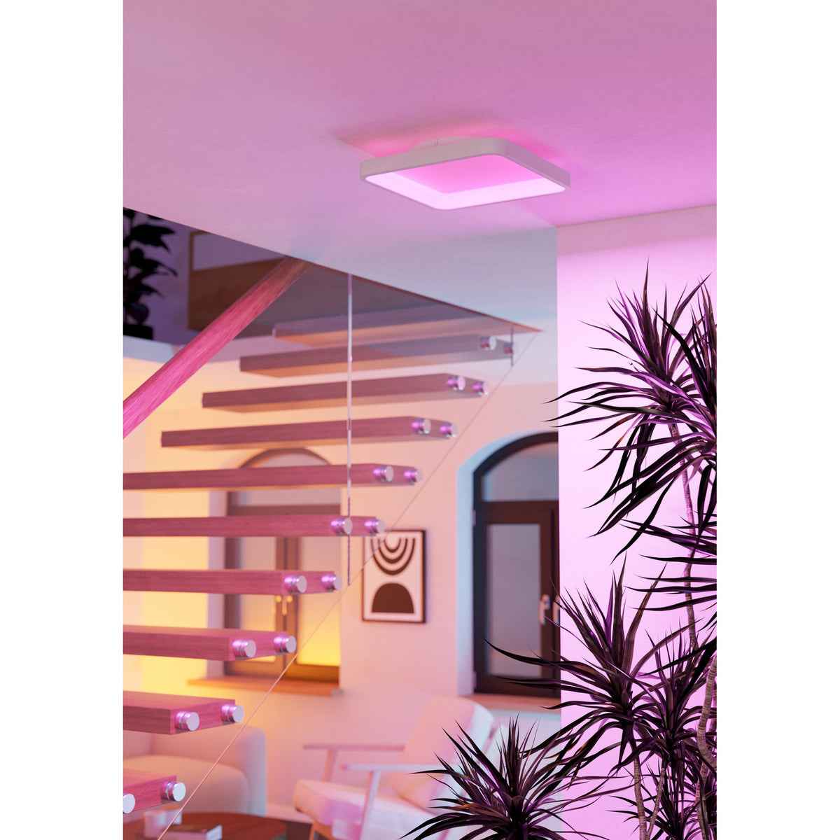 Loretello Smart LED Flush Ceiling Light, 35 x 35cm square white fixture glowing pink, mounted on ceiling above a staircase in a modern hallway setting.