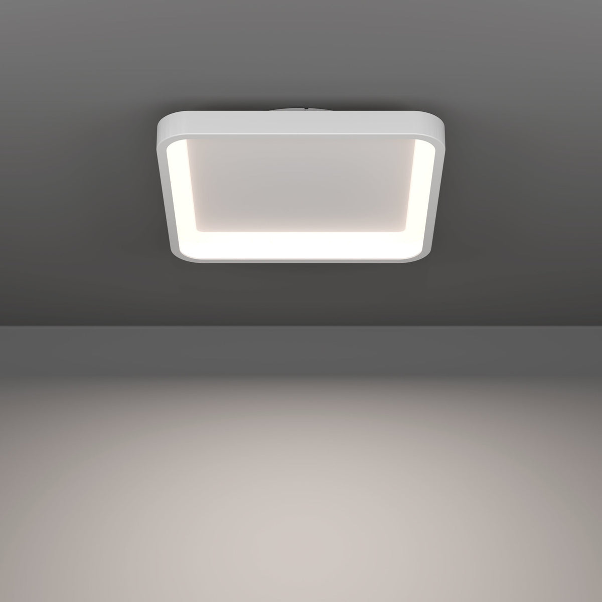 Loretello Smart LED Flush Ceiling Light, 35 x 35cm square fixture with rounded corners, white steel body and illuminated edge diffuser, mounted on a grey ceiling.