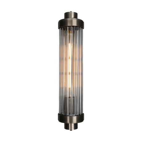 Louise Ribbed Glass Wall Light IP44, a cylindrical wall light with clear ribbed glass and stepped brass end caps, lit by a single central bulb, shown on a plain white background.