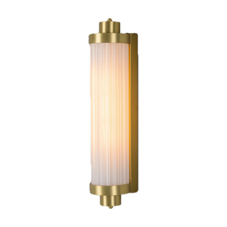 Louise Ribbed Glass Wall Light IP44 in Opal, a tall cylindrical glass shade with vertical ribs, brass end caps and backplate, lit on a plain white background.