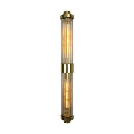 Louise Twin Clear Ribbed Glass Wall Light IP44 with two vertical ribbed glass tubes joined by a brass centre collar, glowing amber bulbs visible, on a plain white background.