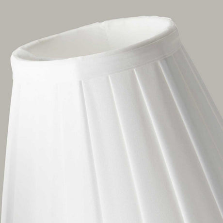 A close-up of the Clip Shades Pleated White Candle Shade, crafted from polycotton fabric, against a plain background highlights its simple and elegant design, making it a timeless addition to any lighting fixture.