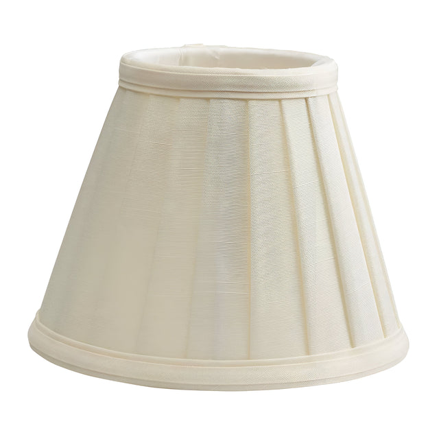 Introducing the Clip Shades Pleated Ivory Candle Shade, featuring a classic conical design and crafted from polycotton. This candle shade is ideal for table lamps, with its subtly visible fabric texture that adds a traditional and elegant touch.